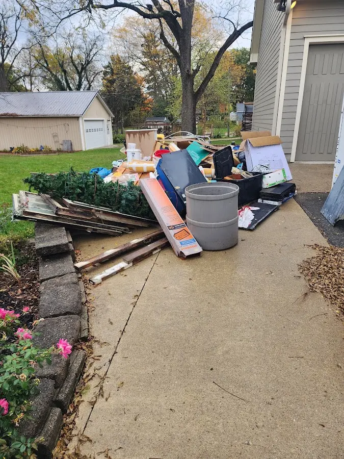 Dumpster being loaded with debris for Estate Cleanout Dumpster Rental in Lighthouse Point